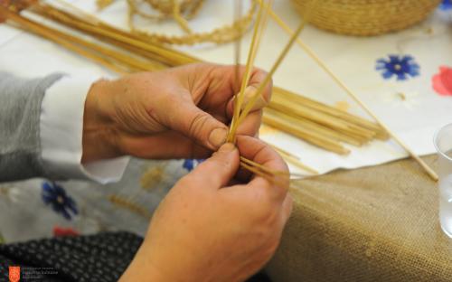 Making braided straws for straw hats. 