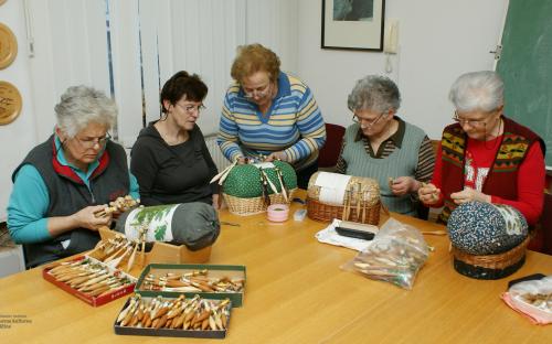 Members of the Bobbin lace Association Cvetke Žiri while making bobbin laces.